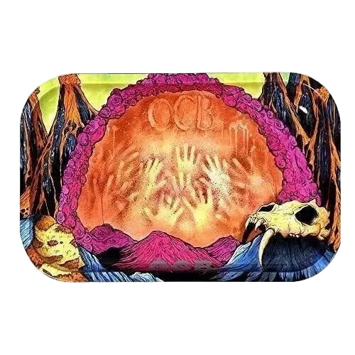 A rectangular rolling tray with rounded corners, featuring a highly detailed psychedelic illustration. The design shows a large orange and yellow central circle with handprints and the letters 'OCB', surrounded by a purple border, with dark brown and black tree-like silhouettes and a skull on a blue and yellow background.