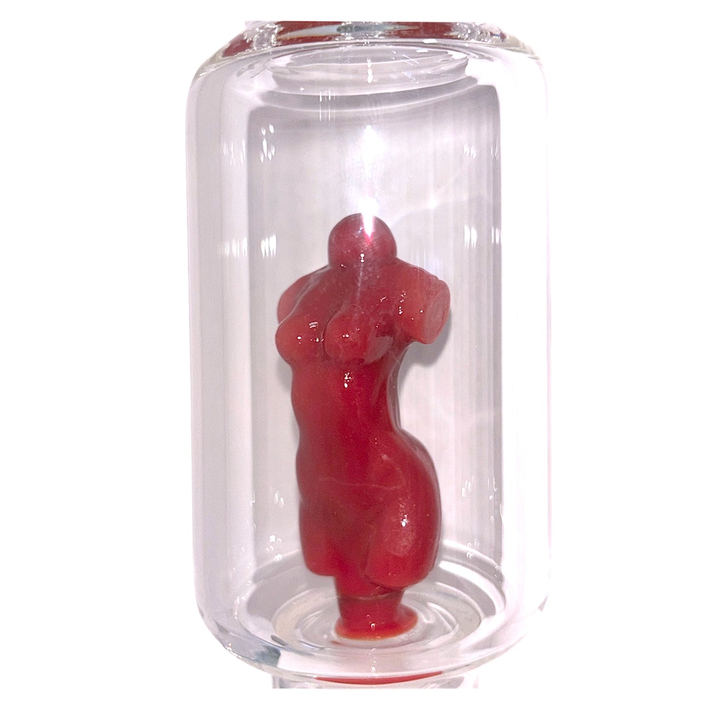 Close-up of clear glass bong chamber with red sculpted goddess figure inside