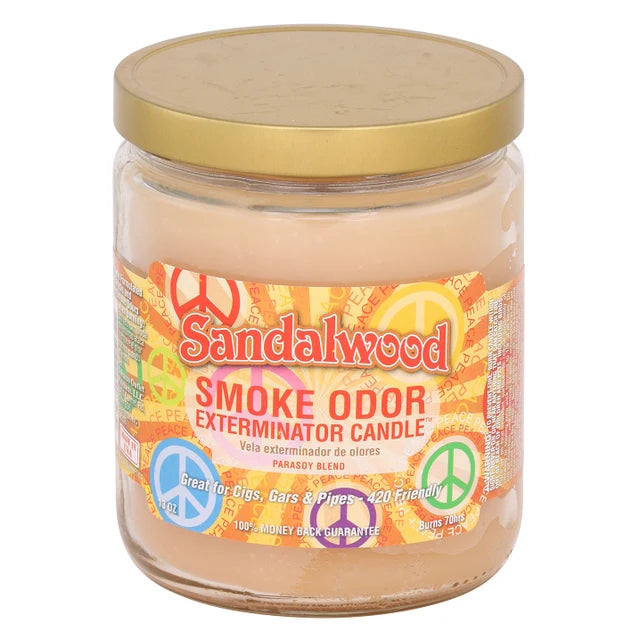 A glass jar candle with a gold metal lid and a colorful label reading 'Sandalwood Smoke Odor Exterminator Candle' on a white background. The Wee Smoke Shop