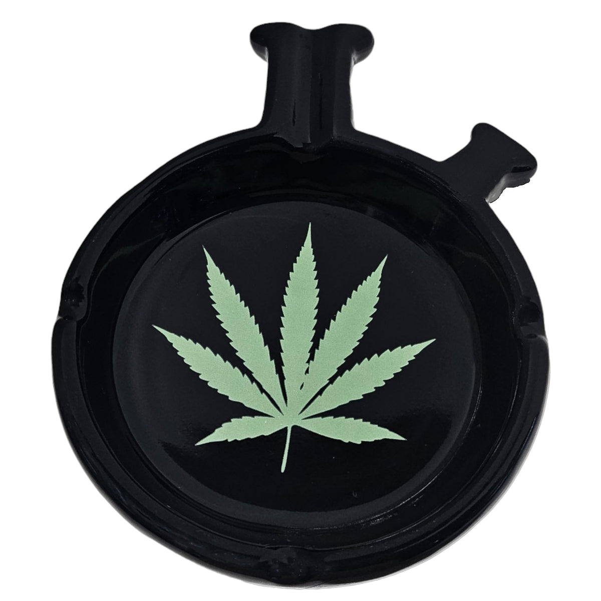 Black round ashtray with a glossy finish, built-in cigarette rests around the edge, and a light green cannabis leaf design printed in the centre. The Wee Smoke Shop
