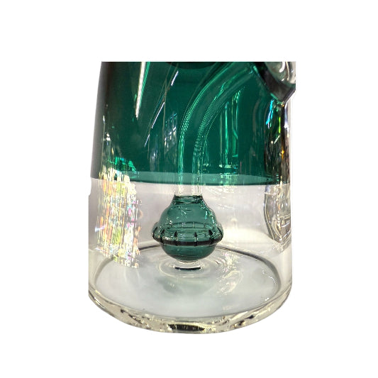Close-up of a glass with green top and clear base on a white background