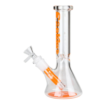 Clear 7.5 inch Cookies graphic beaker bong with orange vertical lettering, orange base accent, angled bowl, and removable downstem on a white background.- The Wee Smoke Shop