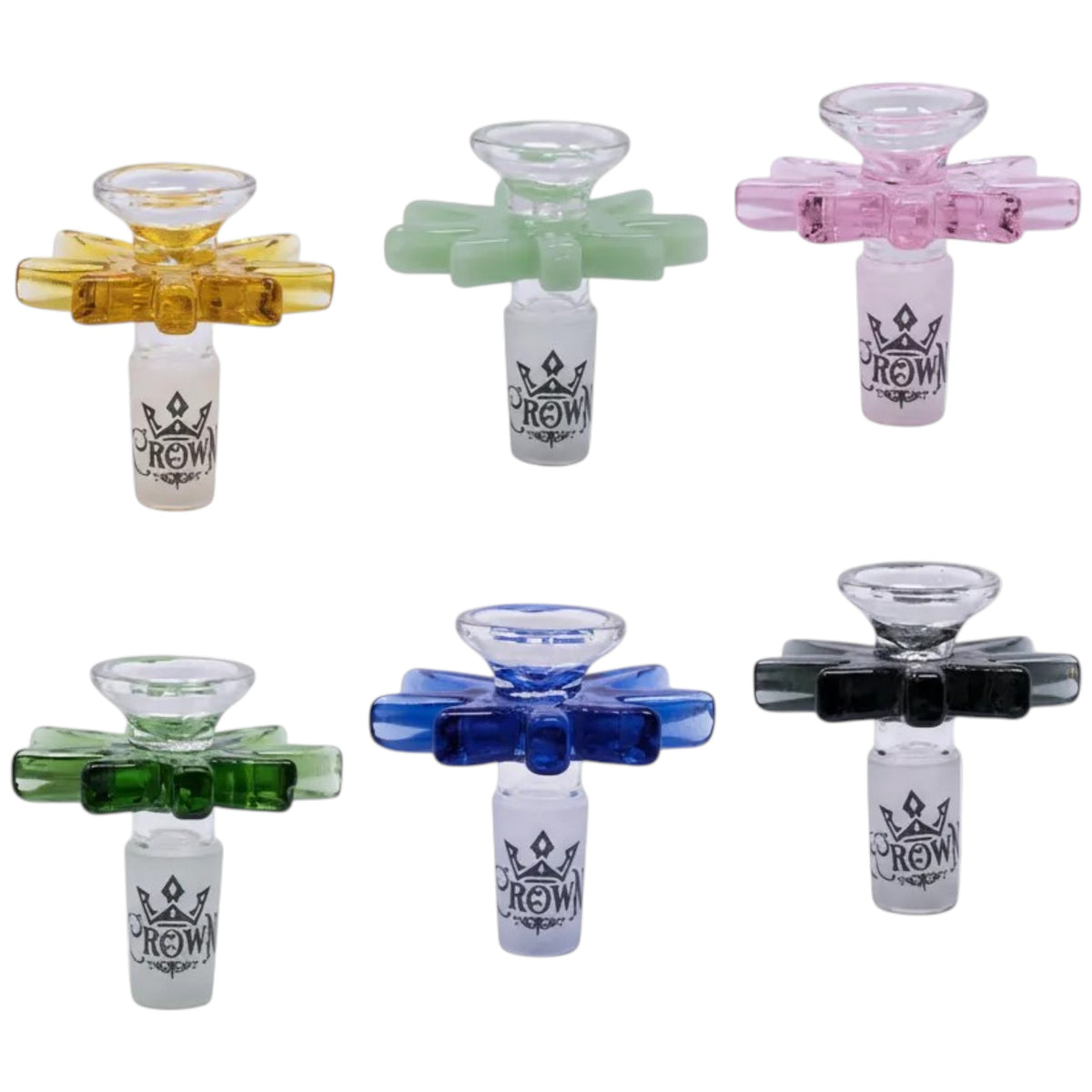 Assorted weed leaf glass herb bowls shown together in amber, mint green, pink, dark green, blue, and black, each with a leaf-shaped bowl design, side handle, and white Crown logo joint. The Wee Smoke Shop
