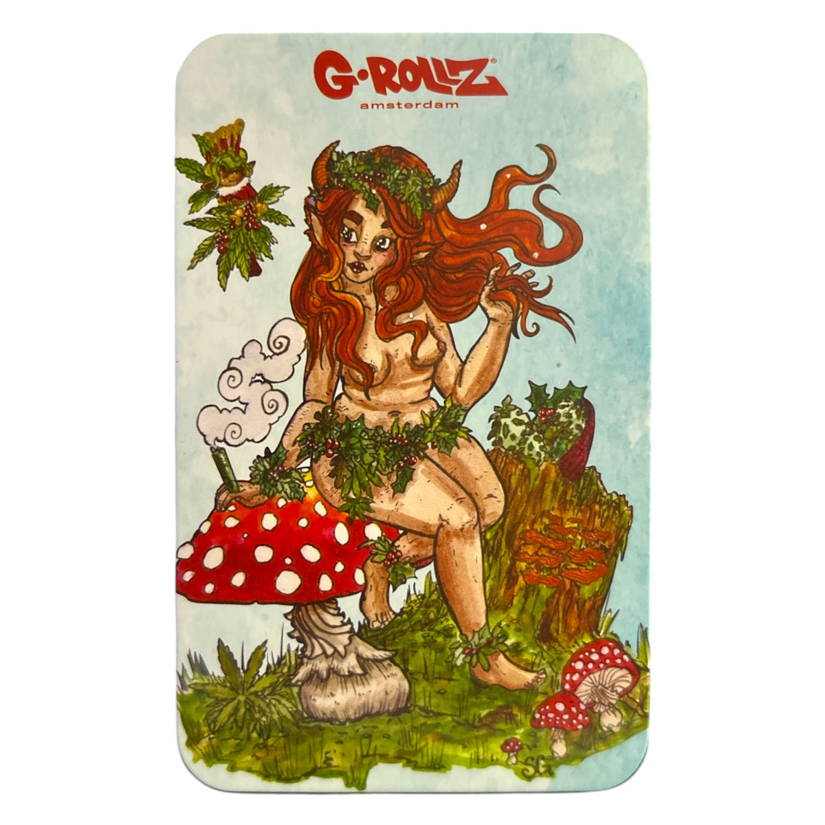 G-Rollz metal storage tin lid featuring a red-haired woodland fairy sitting on a red and white spotted mushroom, surrounded by plants, flowers, and forest scenery.