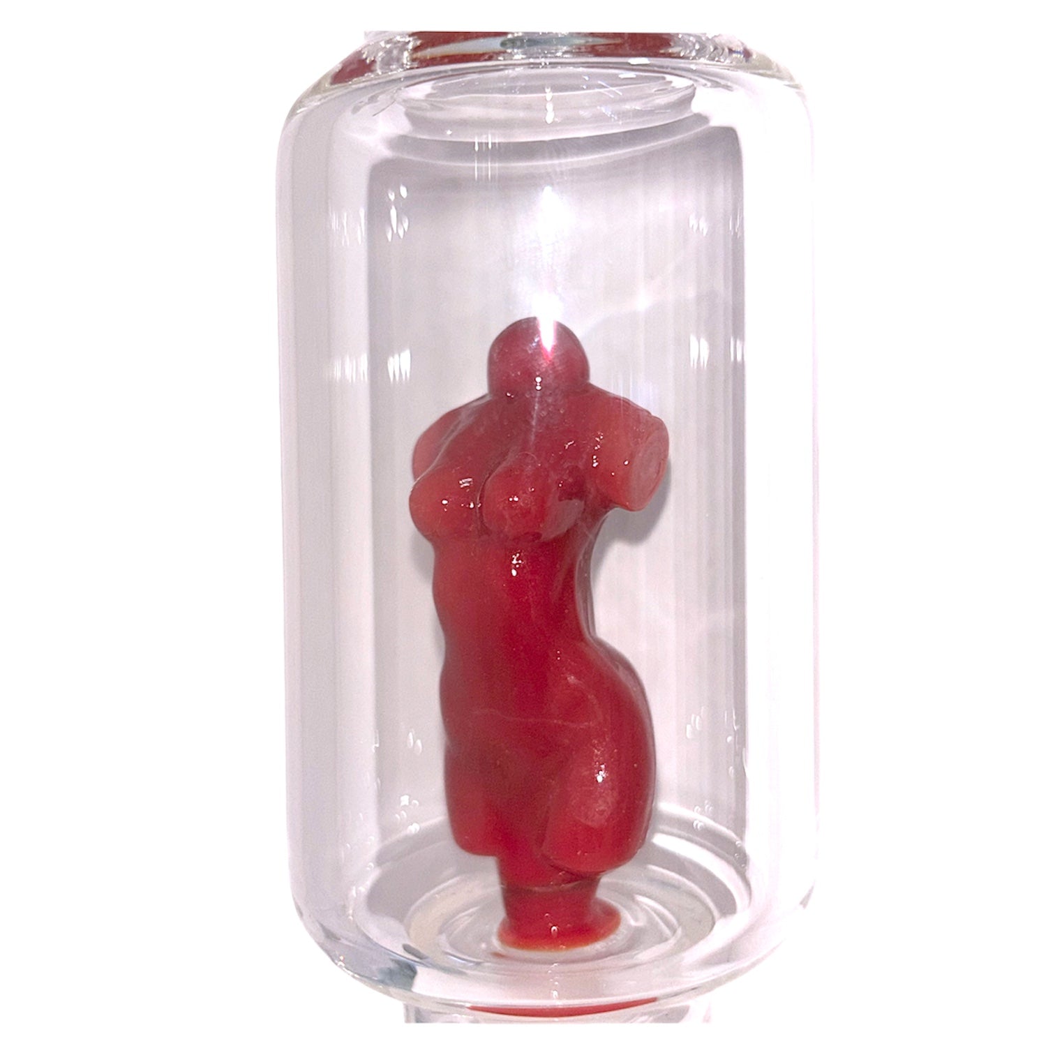 Close-up of clear glass bong chamber with red sculpted goddess figure inside