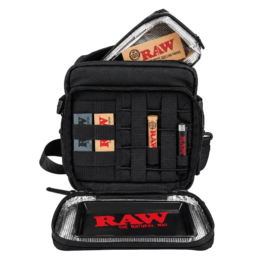 A black and brown RAW x Rolling Papers Day Bag with a cork top and a foil-sealed bag-in-a-bag, featuring Velcro-swappable patches and multiple compartments.