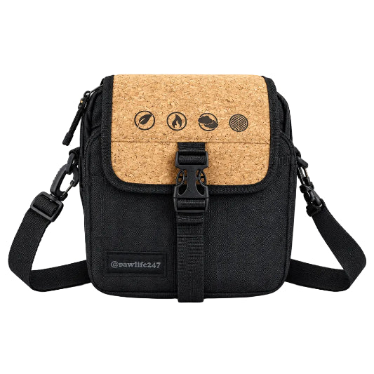 A black and brown RAW x Rolling Papers Day Bag with a cork top and a foil-sealed bag-in-a-bag, featuring Velcro-swappable patches and multiple compartments.