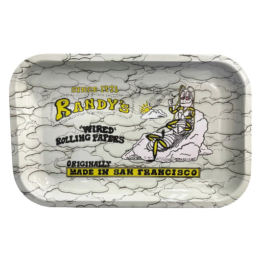 Rectangular metal rolling tray with rounded corners and raised edges, featuring a grey and white cloud-patterned background, yellow and black Randy's branding, and a cartoon character relaxing on a cloud. Text includes "Since 1975," "Wired Rolling Papers," and "Originally Made in San Francisco."