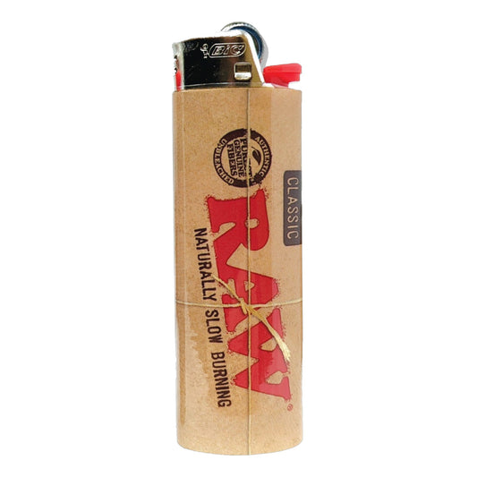 RAW Classic Bic lighter with tan rolling paper design, red RAW logo, and naturally slow burning text. - The Wee Smoke Shop