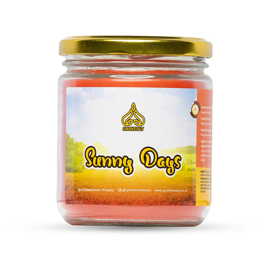SmokeOut Sunny Days 13oz odour-neutralizing candle in glass jar with gold lid and sunny landscape label. - The Wee Smoke Shop