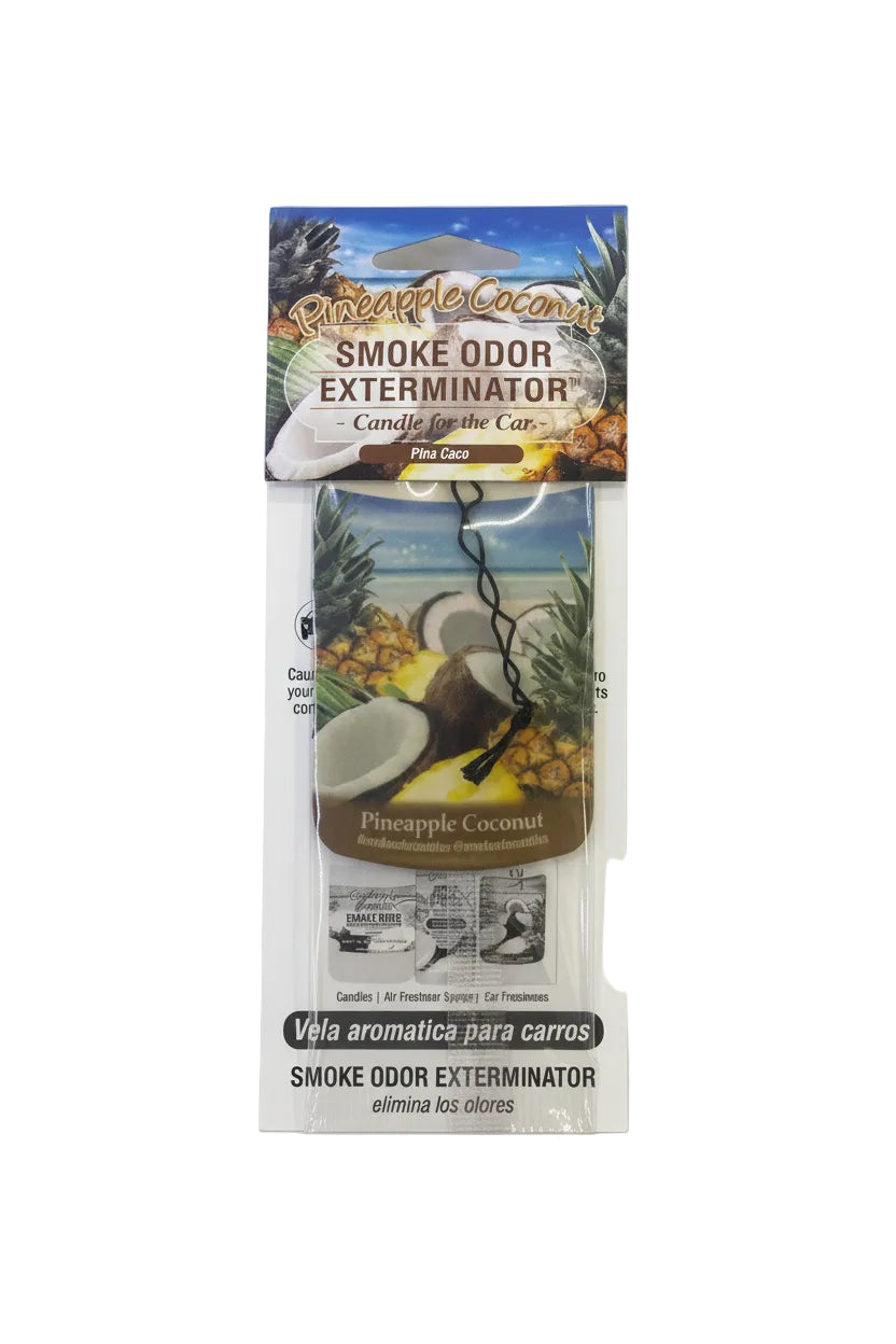 Smoke Odor Exterminator Pineapple Coconut hanging car air freshener in clear packaging, featuring tropical pineapple, coconut, and beach artwork with “Pineapple Coconut” and “Smoke Odor Exterminator” text visible on the front. - The Wee Smoke Shop