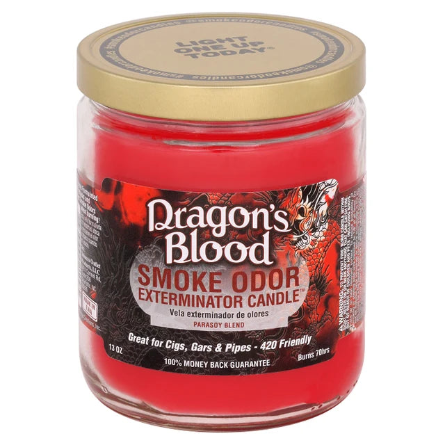 A 13 oz glass jar candle with bright red wax and a metallic gold lid. The front label features the brand 'Dragon's Blood' and the scent name 'Smoke Odor Exterminator Candle' with a red and black dragon graphic.