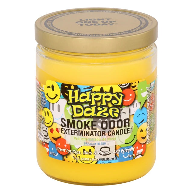 A glass jar candle with a gold lid by Happy Daze, featuring a colorful label with smiley faces and the text 'Smoke Odor Exterminator Candle' on a white background.