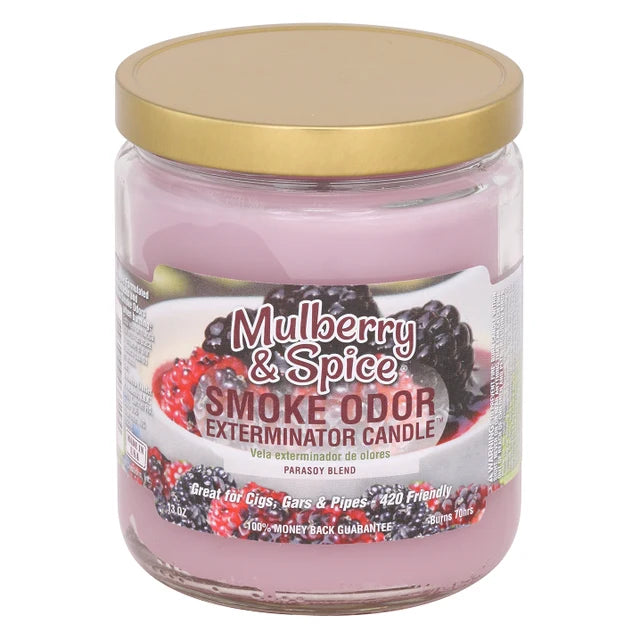 A glass jar candle with a gold lid and a pink wax body, labeled 'Mulberry & Spice Smoke Odor Exterminator Candle' with a graphic of fresh berries.