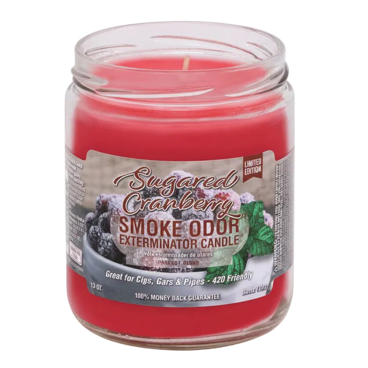 Red candle in a jar with a label on a white background - The Wee Smoke Shop