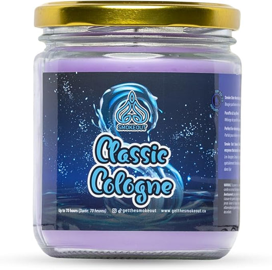 A glass jar candle with a gold metal lid and a dark blue label reading 'Classic Cologne' by Smokeout. The candle wax inside is light purple, visible at the top and bottom of the jar against a white background. - The Wee Smoke Shop