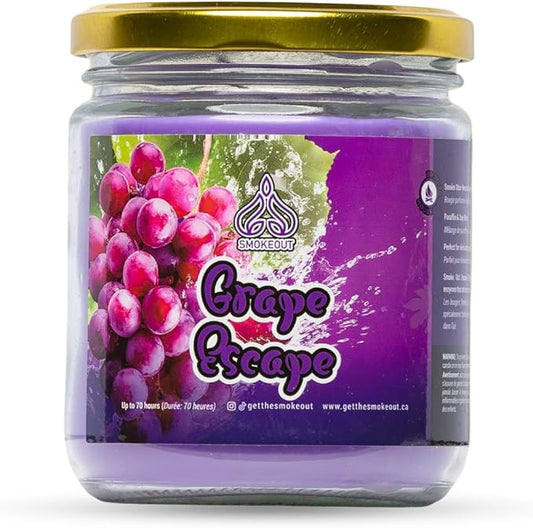 A glass jar candle with a gold metal lid and a purple grape-themed label reading 'Grape Escape' by Smokeout, shown on a white background. - The Wee Smoke Shop