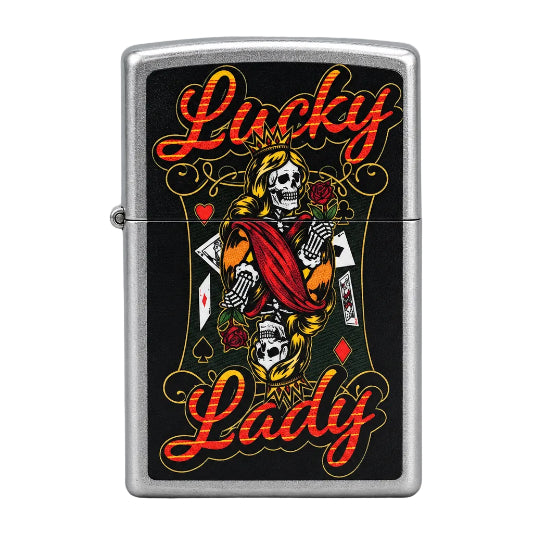 A silver metal lighter with a black front panel featuring a tattoo-style illustration of a skeleton playing card draped in red, with the words 'Lucky Lady' in red and gold script.