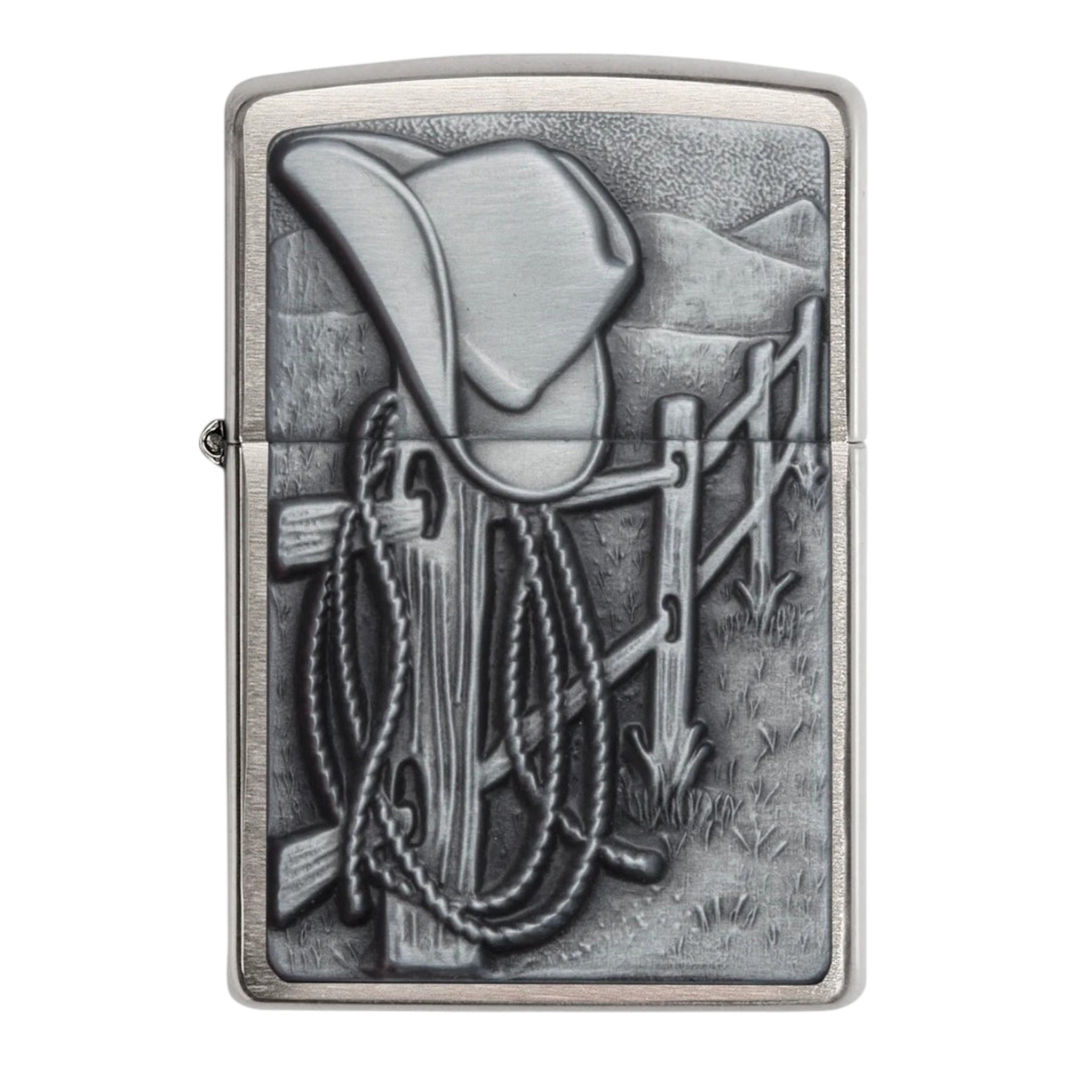 Silver Zippo windproof lighter with a detailed raised Western scene featuring a cowboy hat resting on a wooden fence, a coiled rope lasso hanging from the posts, and grassy hills in the background. Features an antique silver finish, textured metal detailing, and a classic flip-top lid, shown from the front on a white background.