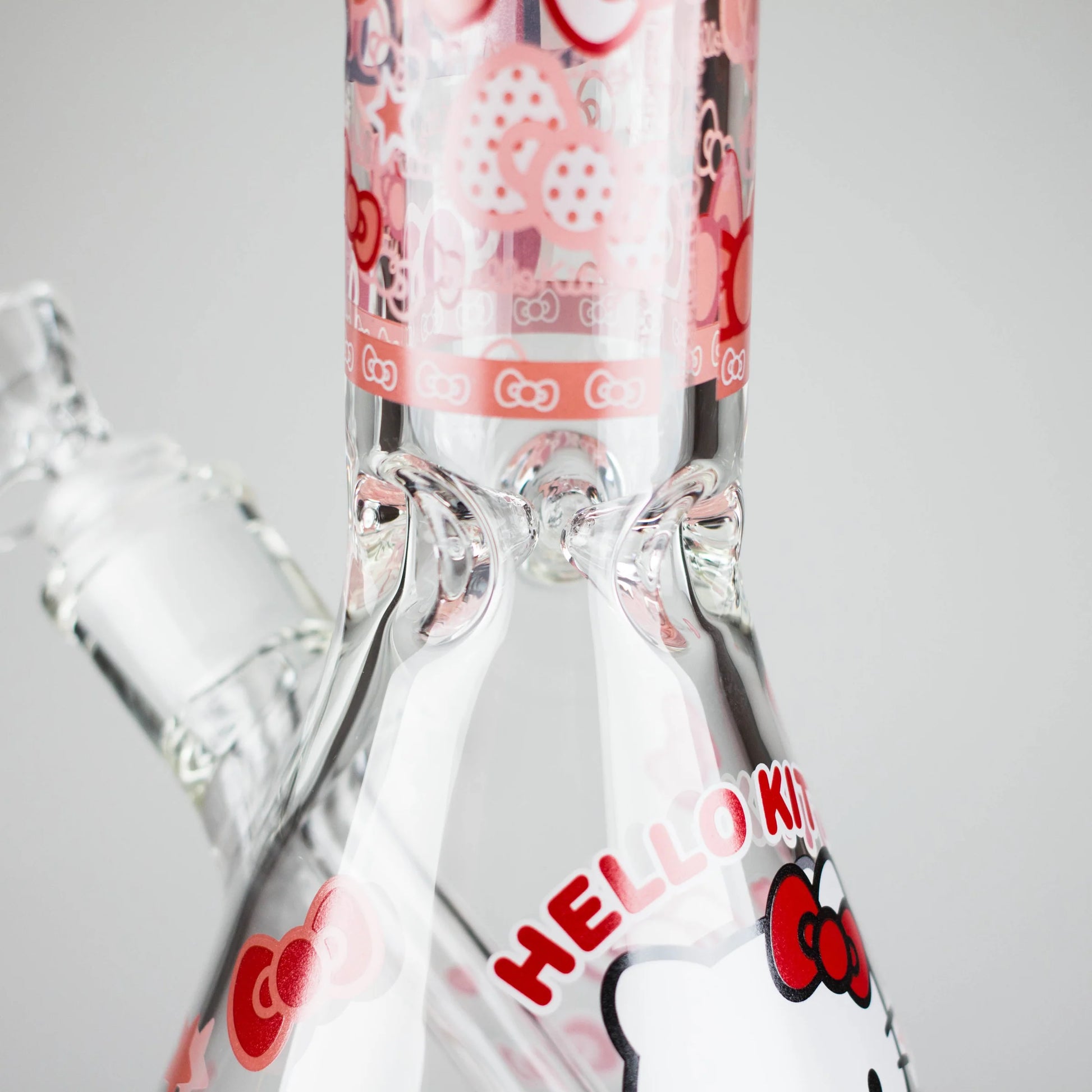 Clear glass pipes with Hello Kitty branding on a gray background