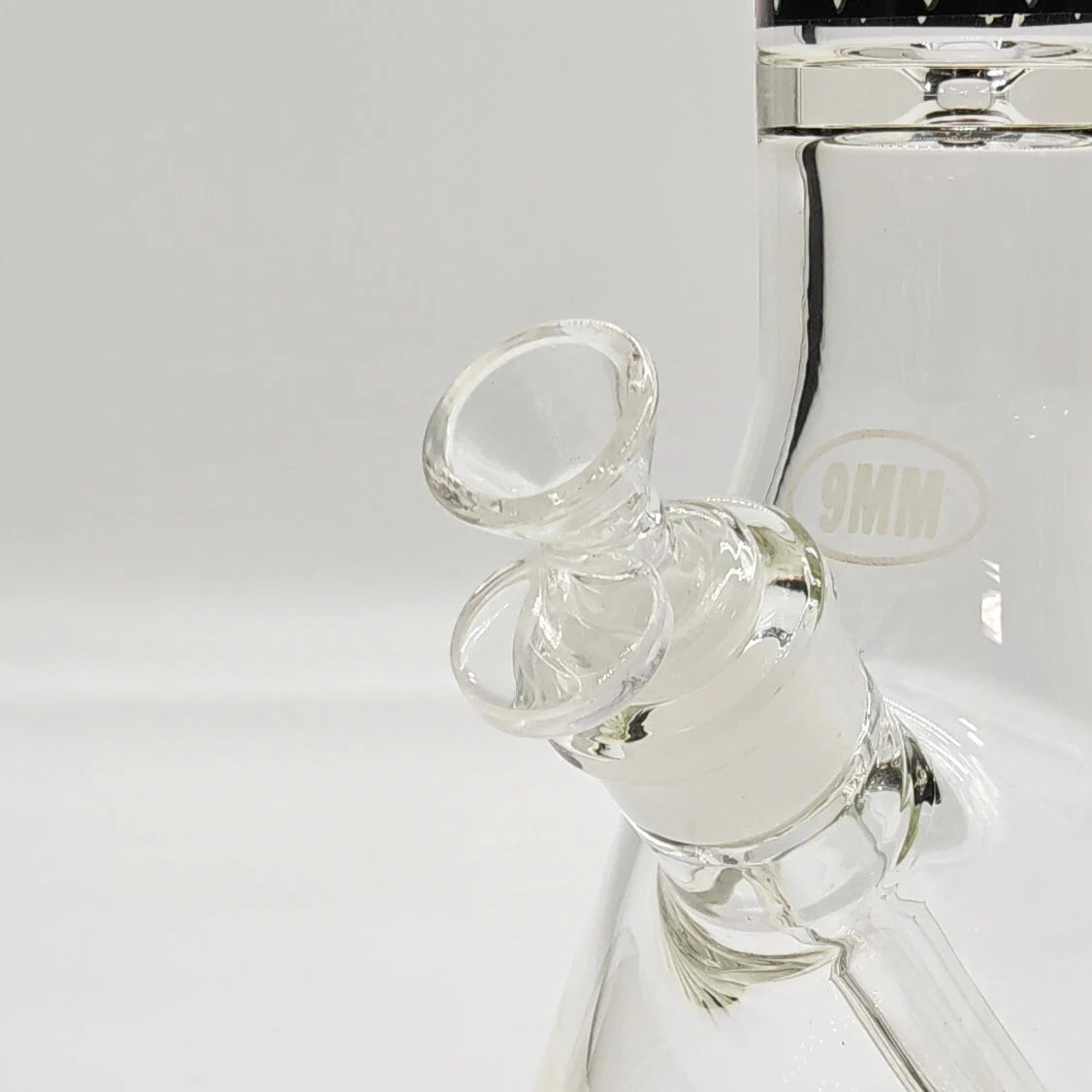 Close-up of a glass water pipe with a white background