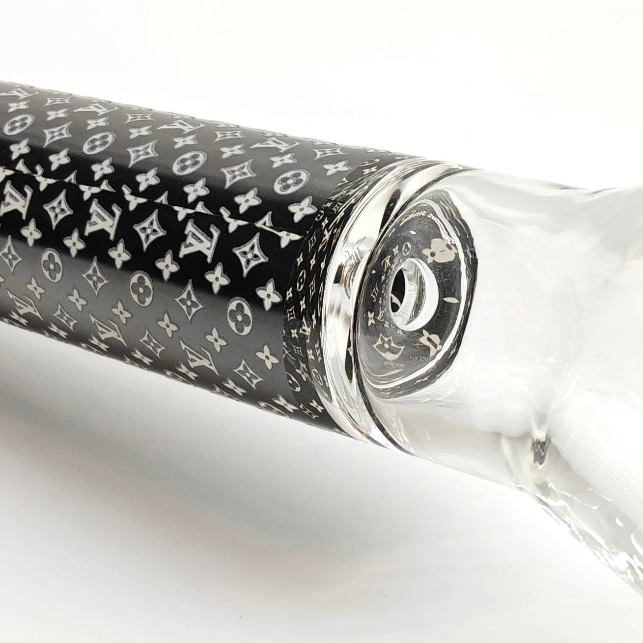 Glass pipe with black and white patterned sleeve on a white background