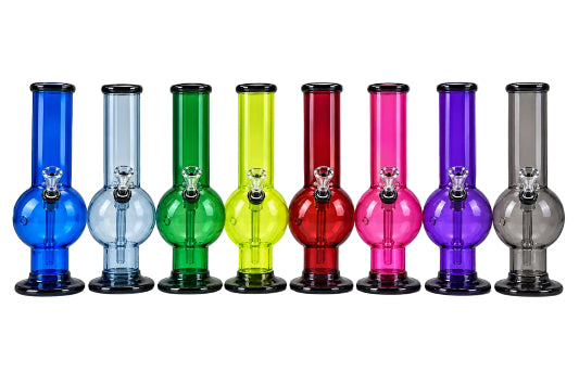 A collection of colorful acrylic bongs in various colors including blue, green, pink, purple, red, and clear, all displaying the Herbies brand logo.